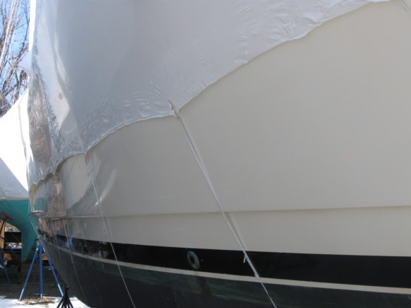 Shrink wrapped boat with belly bands fastened to the perimeter band around hull