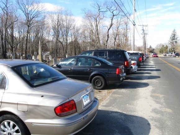 Cars parked beside the cemetery on North Main Street