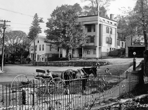 Just an ordinary day in Chester Center in 1913, photographed by Hugh Spencer, and on exhibit at the Chester Museum at The Mill. A horse-drawn cart is parked in the center of town. Just up from the wagon is a gas pump. Also nearby is the stone wall, with “Chester” spelled out in white stones, where the trolley stopped during the years it served Chester (photo by Skip Hubbard).