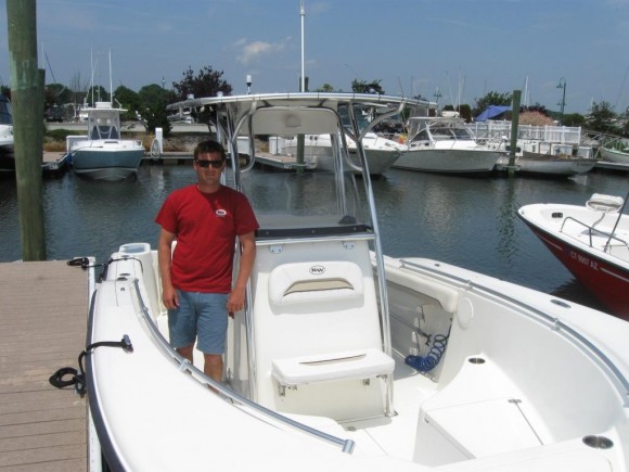 Pilots Point Marina's Kit Will aboard a 24 foot Key West center console, motor boat for rent