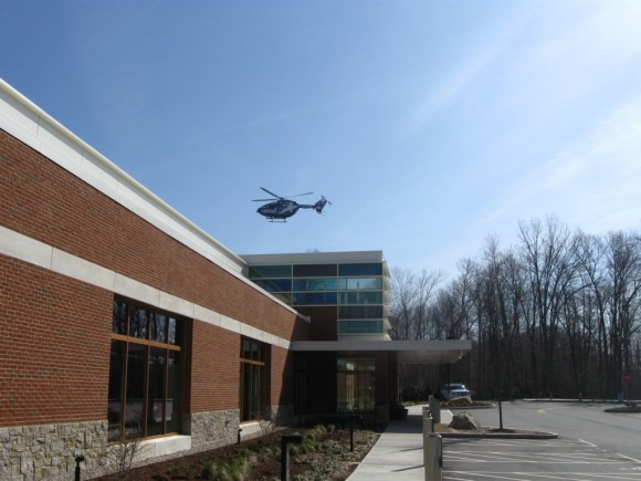 Exterior of Emergency Center with helicopter coming in