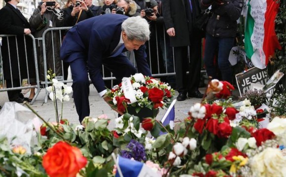 US Secretary of State John Kerry pays his respects at the makeshift memorial in Paris to the Charlie Hebdo victims.