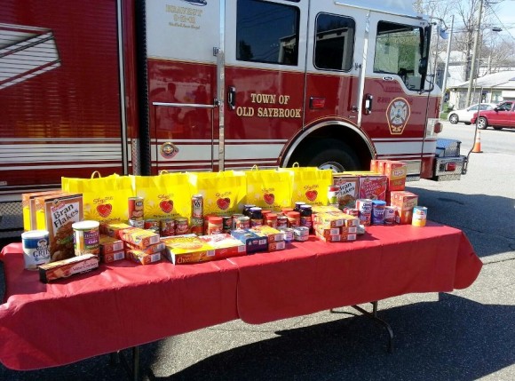 Food donations collected last year are gathered beside an Old Saybrook firetruck 