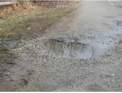 A pothole needing repair on the road to Pettipaug Yacht Club